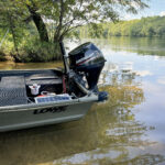 a jon boat moored on the shore at Mountain Island Lake by the Cowan's Ford Dam.